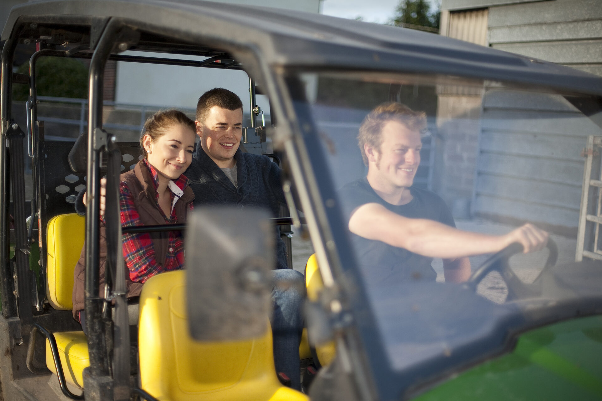 Guests riding in the Gator on a farm tour at Mill Farm Glamping