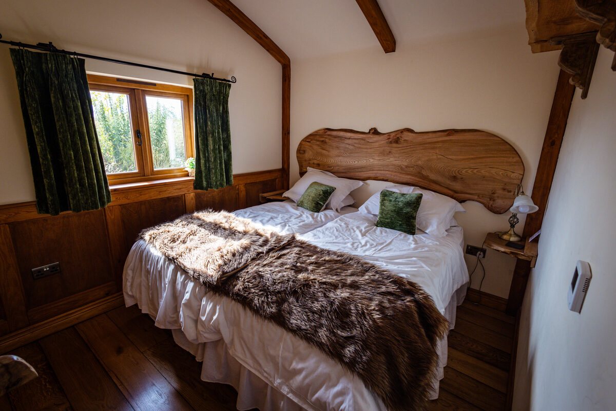 Master bedroom with live-edge headboard & fur throw
