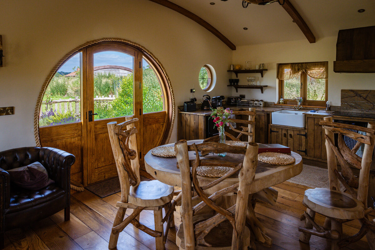 The round door frames the countryside beyond