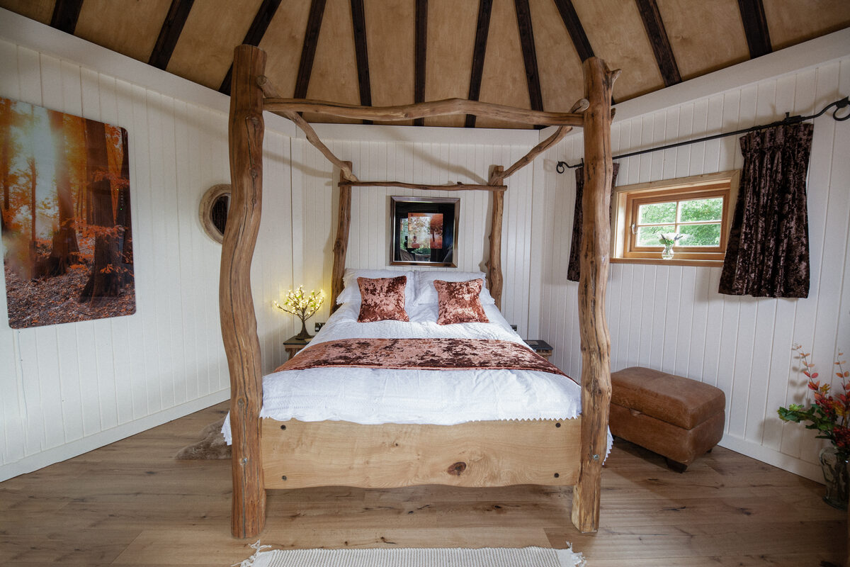 Four-poster master bedroom with log canopy