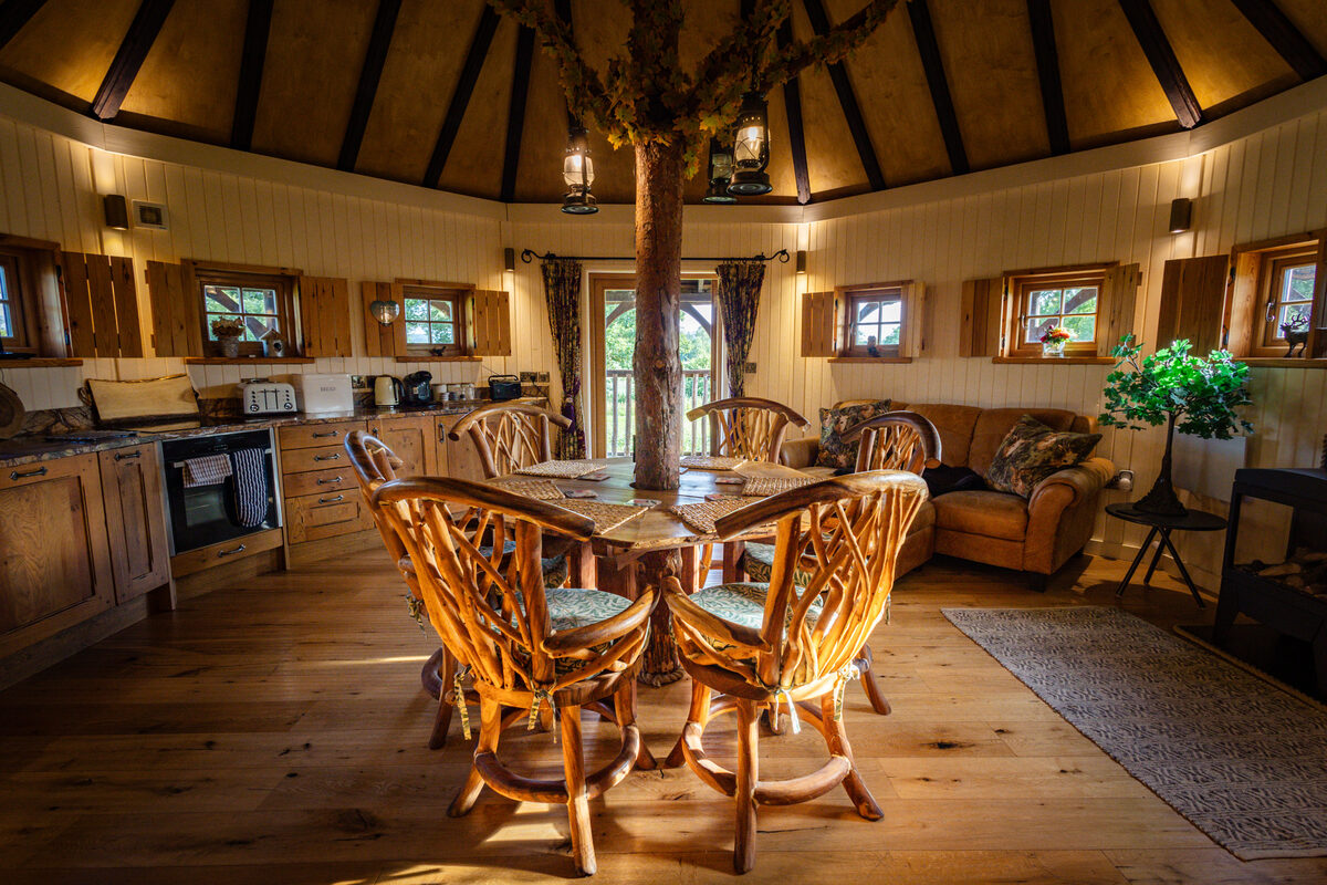 Open-plan living room with tree-trunk centrepiece