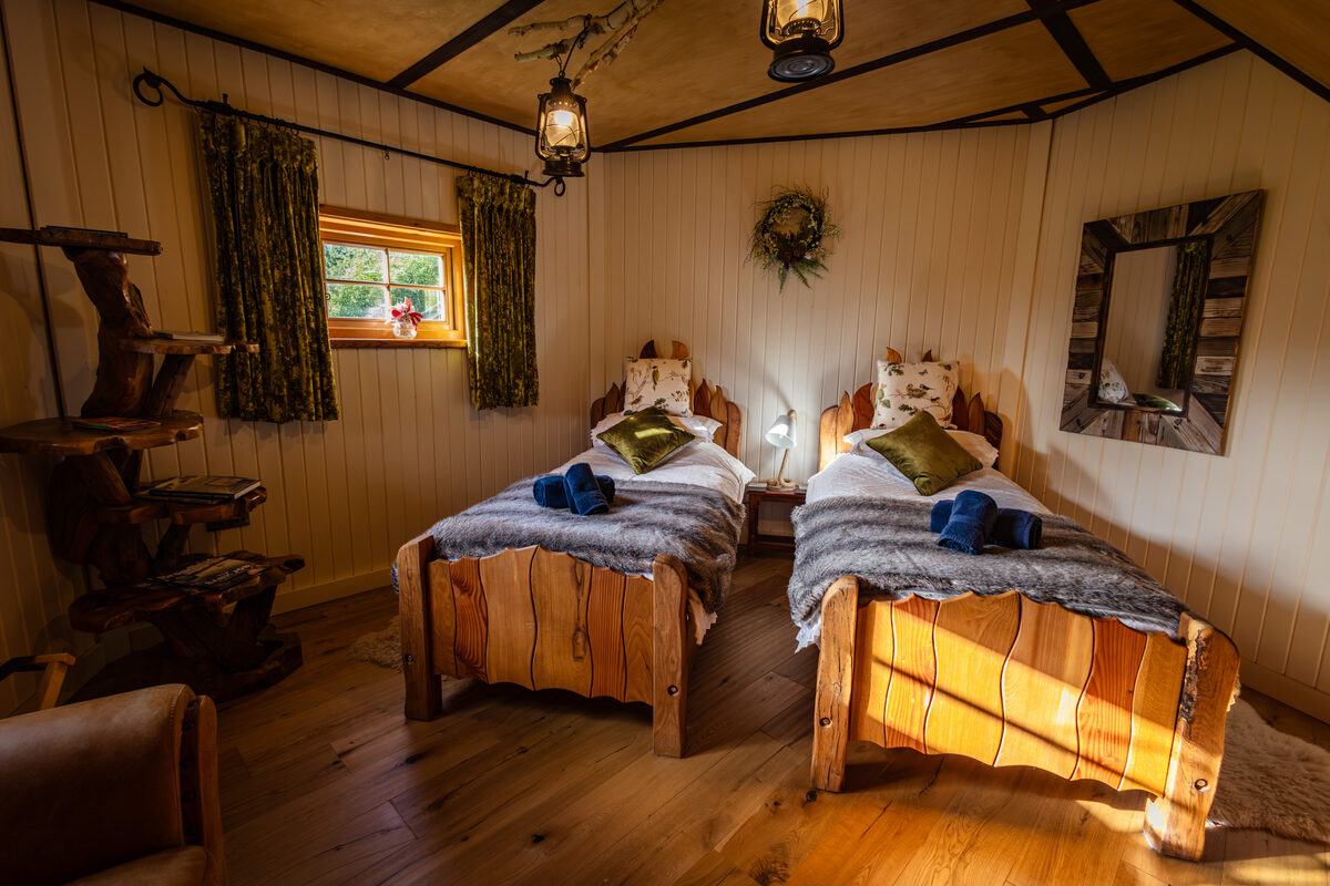 Twin room lit by vintage lanterns